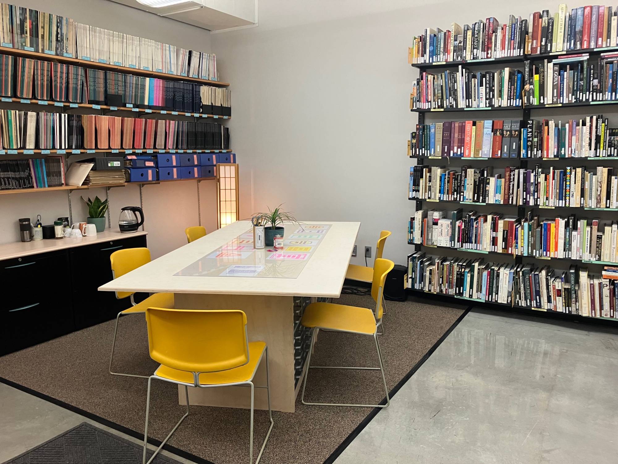 image of the VRC worktable area surrounded by books and with colorful prints on the table